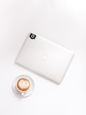 A minimalist design showcasing a laptop and coffee cup.