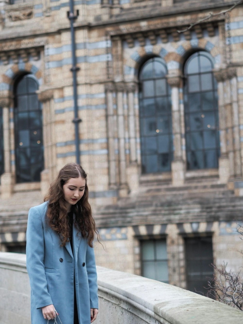 woman standing near building