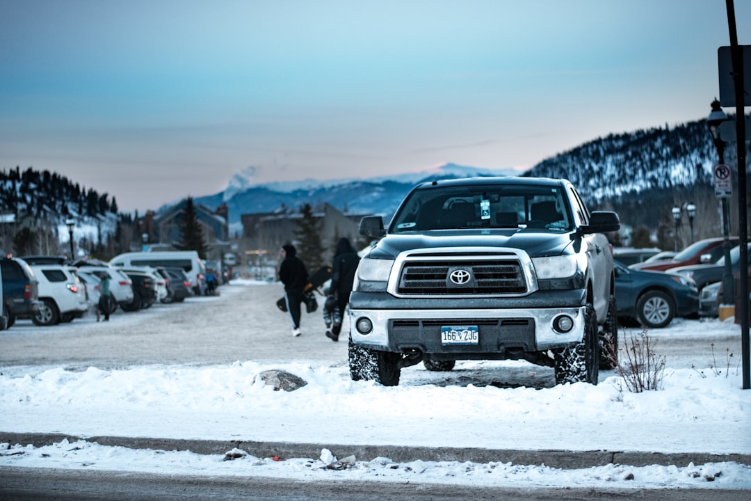 parked white Toyota SUV at parking lot