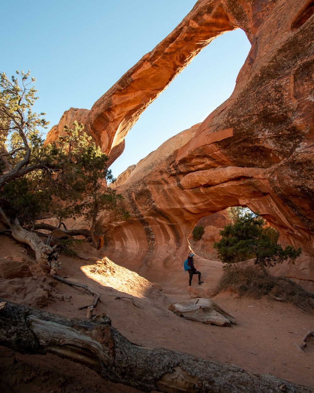 person standing on rock formation during daytime