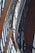 Curved wooden beams and metal architectural elements create a complex and modern structural design. The lines of the materials form an intricate pattern, suggesting a contemporary building or structure with an emphasis on engineering and aesthetics.