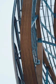 Close-up of sleek metal beam joined seamlessly with warm wooden panels in a modern structure.