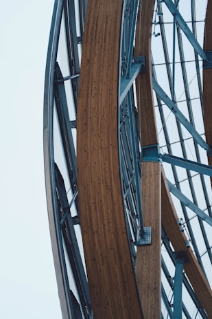 Elegant architectural framework showcasing intersecting steel beams with a muted slate blue backdrop.