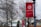 Red banners featuring the Severn School logo and the motto 'Courage to Lead' are displayed on lampposts along a pathway. Bare trees and an American flag are in the background along with several school buildings.