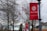 Red banners featuring the Severn School logo and the motto 'Courage to Lead' are displayed on lampposts along a pathway. Bare trees and an American flag are in the background along with several school buildings.