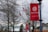 Red banners featuring the Severn School logo and the motto 'Courage to Lead' are displayed on lampposts along a pathway. Bare trees and an American flag are in the background along with several school buildings.