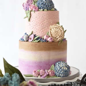 multicolored 2-tier cake on white stand