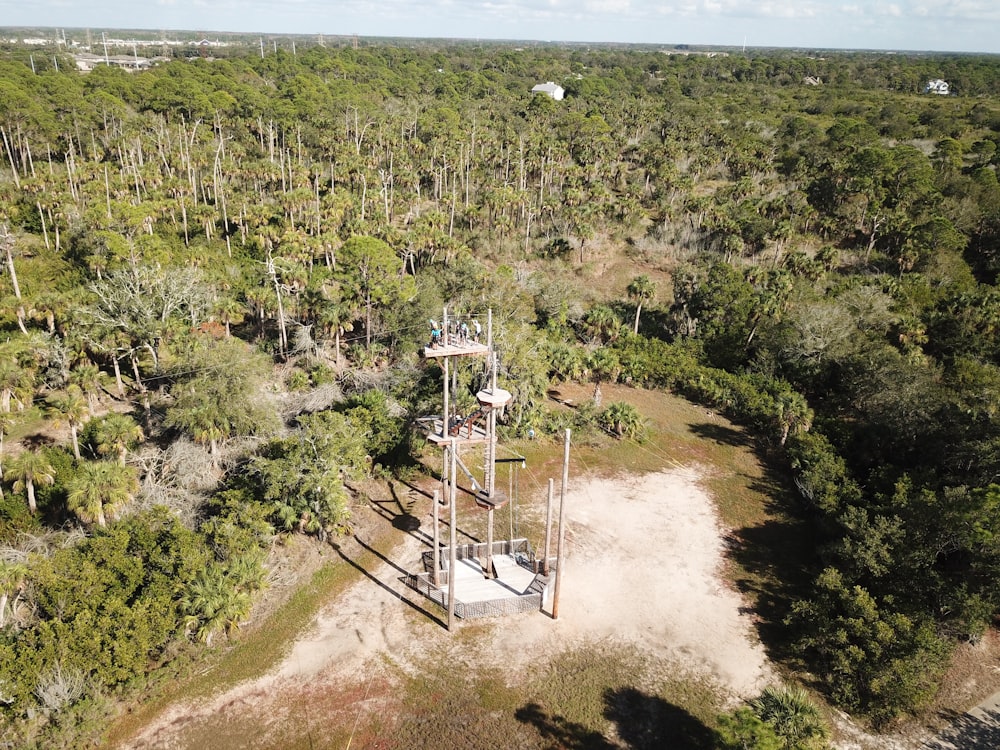 aerial view photography of white tower between forest