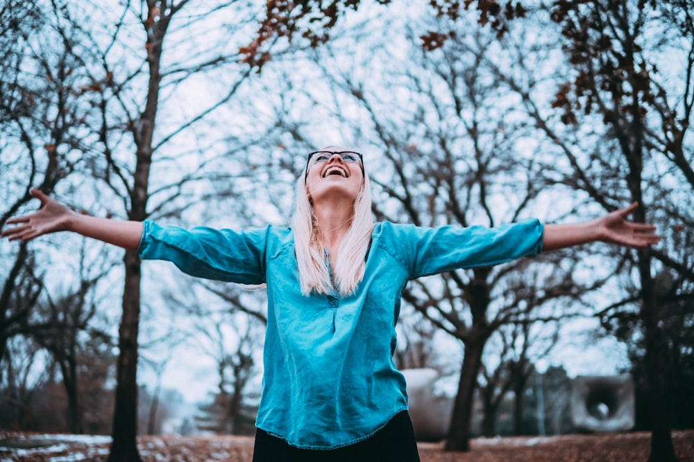 woman spreading arms during daytime