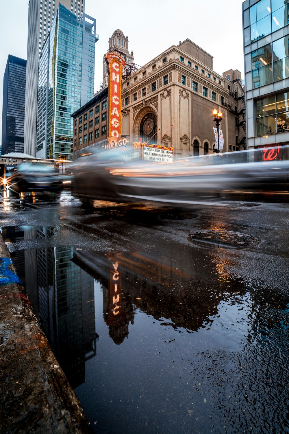 timelapse photography of vehicles on roadway near buildings