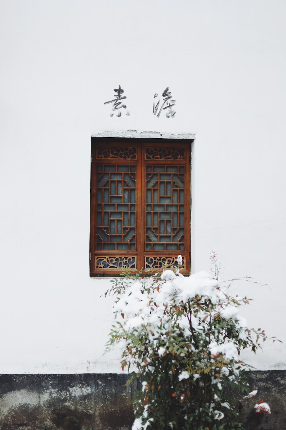 brown wooden double-door window closed during daytime