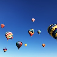 hot air balloons under blue sky during daytime