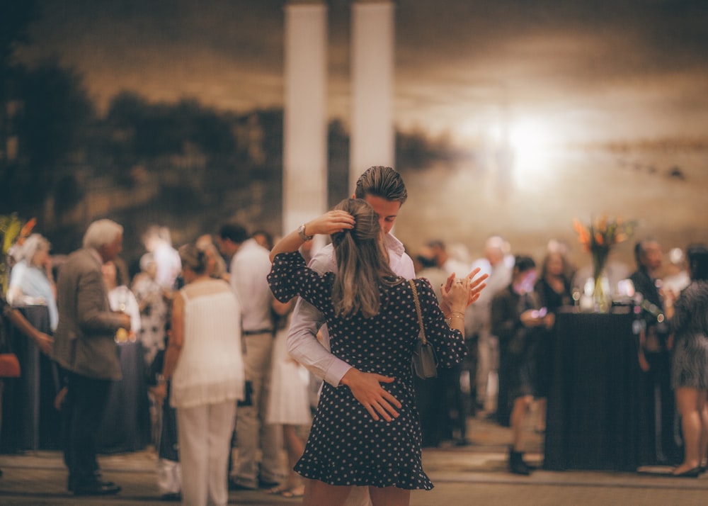 woman in polka-dot dress dancing with man in white dress shirt