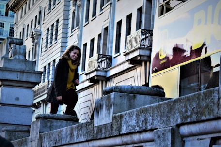 A confident international student smiling with London cityscape in the background.