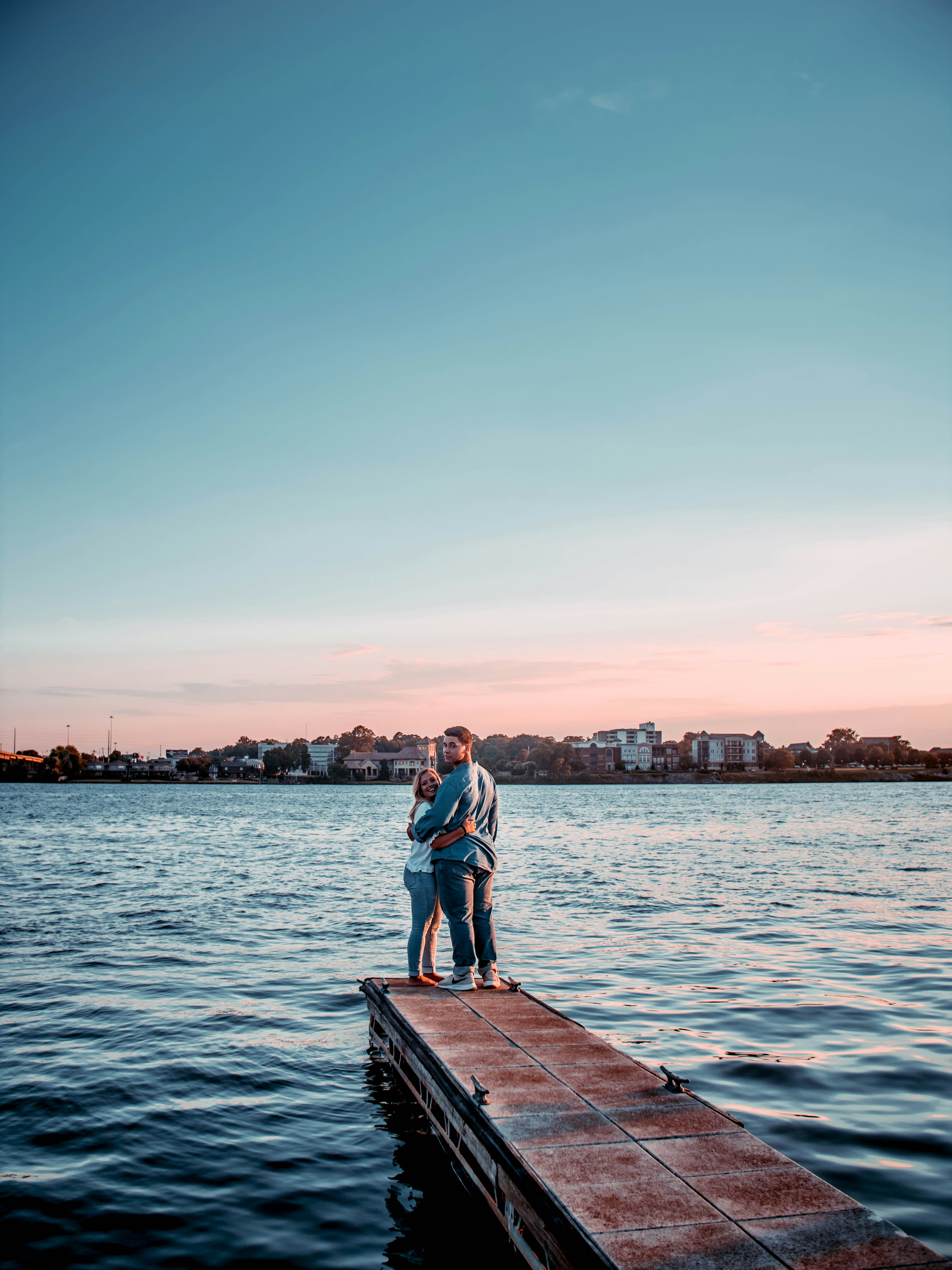 man and woman standing on dock