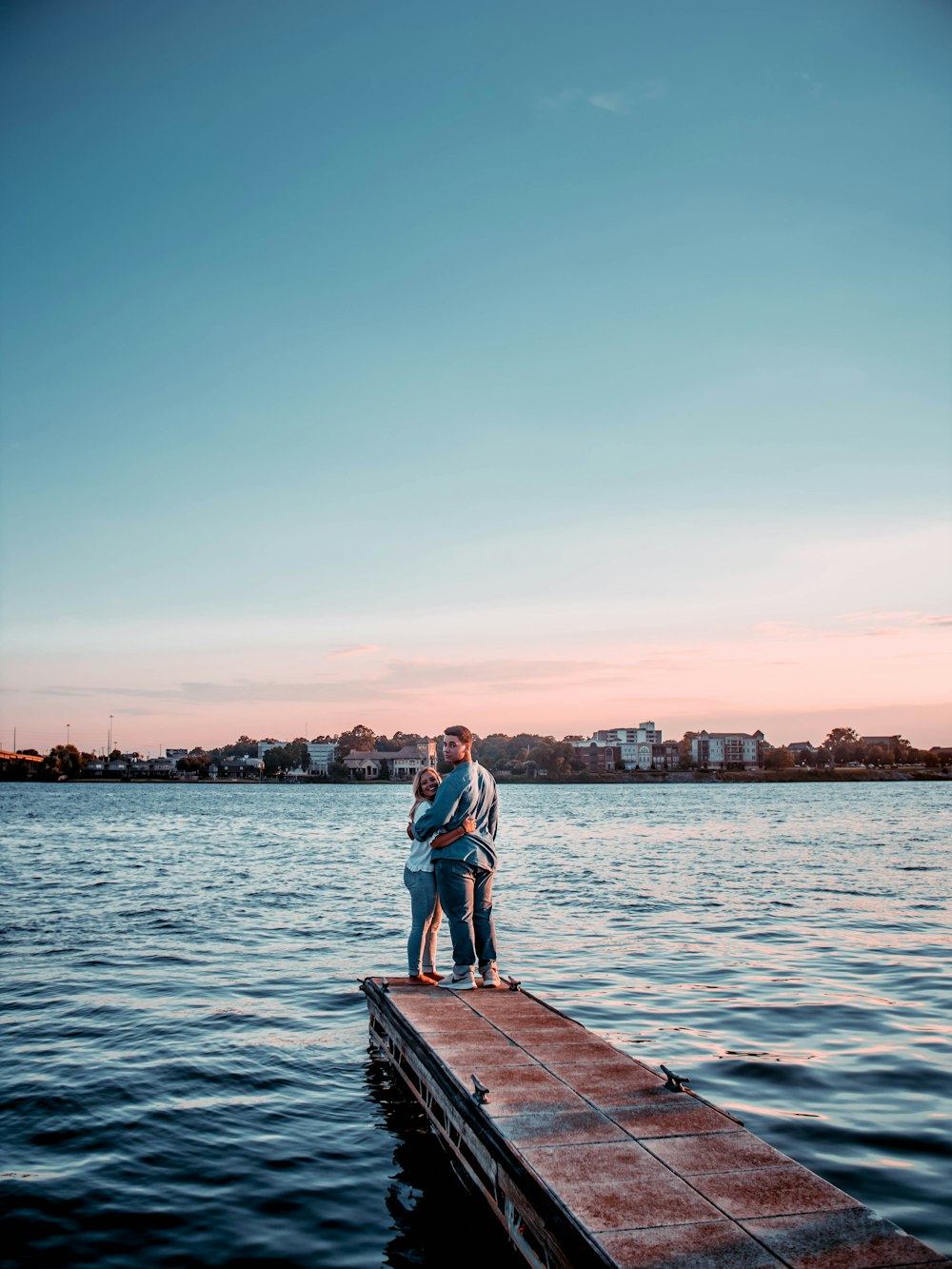 man and woman standing on dock