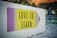 love to learn pencil signage on wall near walking man