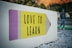 love to learn pencil signage on wall near walking man