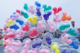 Kids excitedly exploring a colorful Disney park, holding balloons and wearing Mickey ears