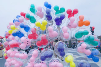 A joyful family entering Disneyland Paris with colorful balloons and castle in the background.