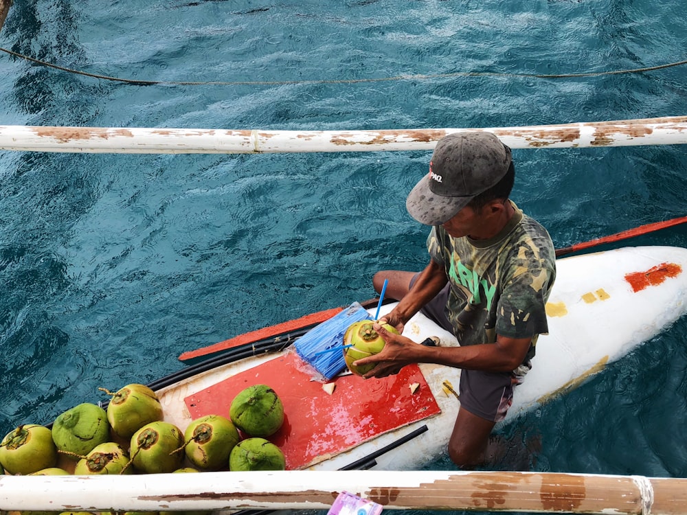 man holding coconut on the boat