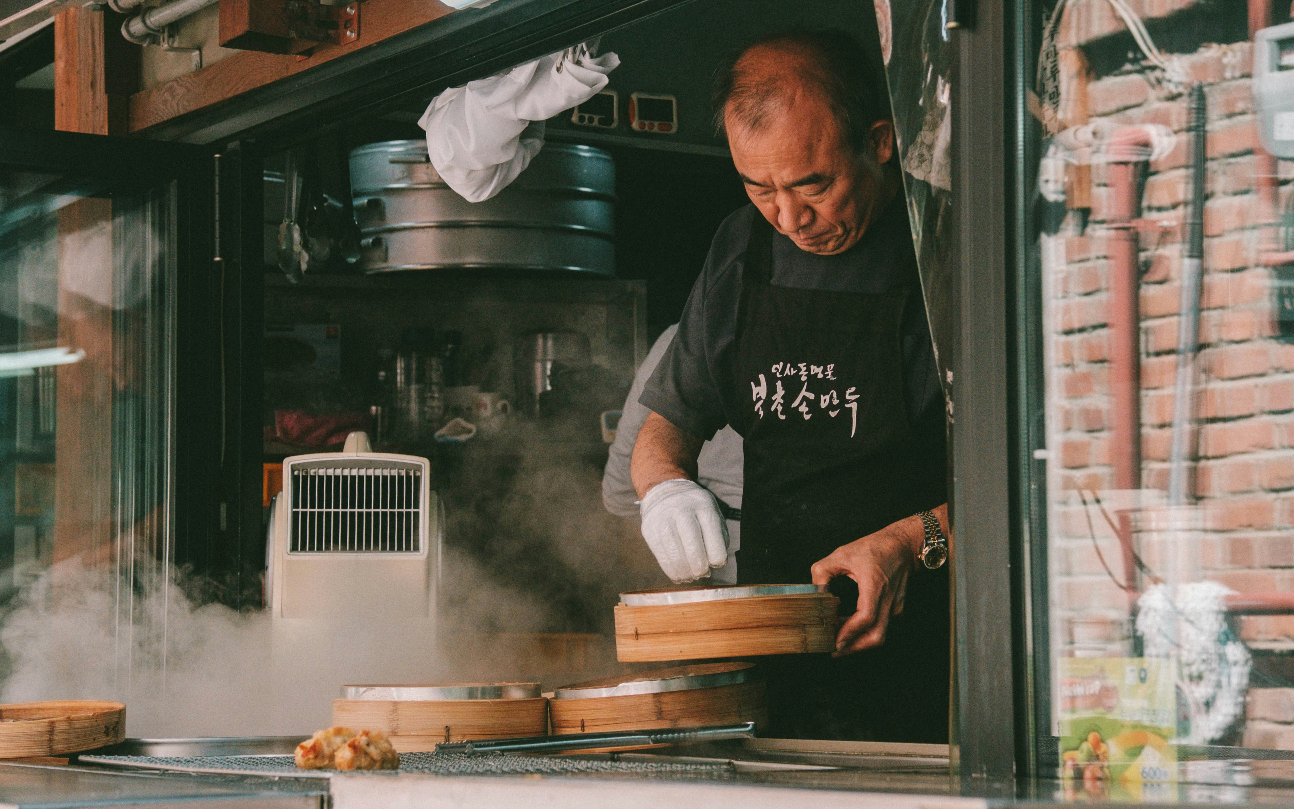 Man holding wooden bowl cooking inside room