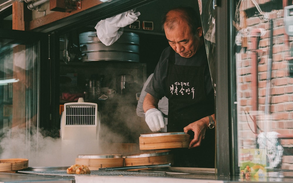 man holding wooden bowl cooking inside room