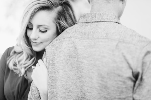 woman smiling holding man's arms