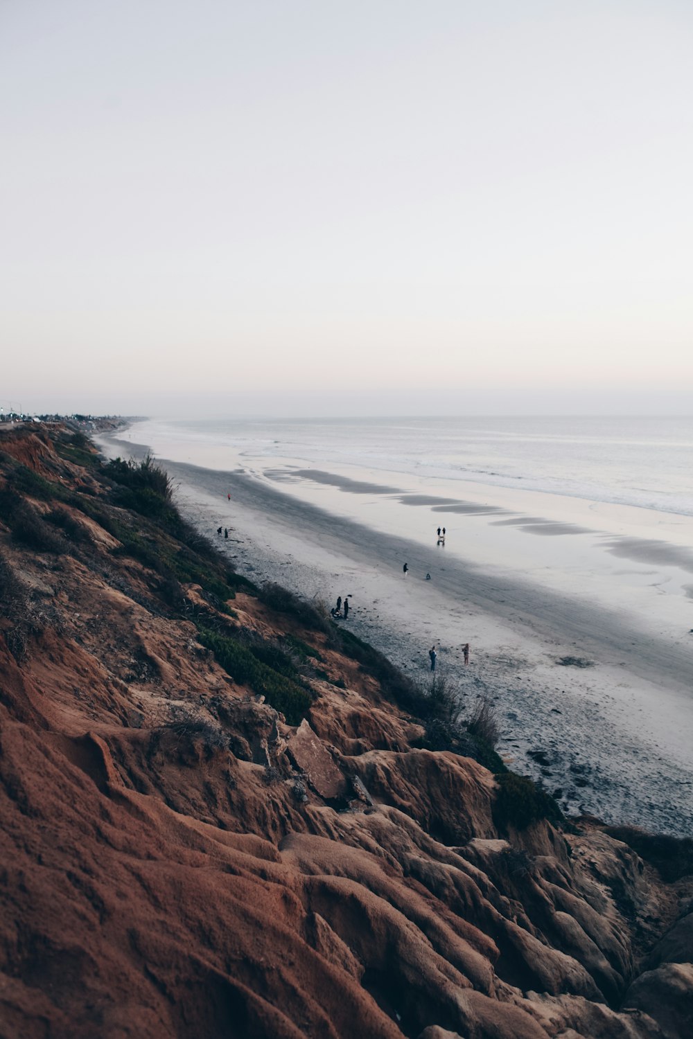 brown mountain beside seashore