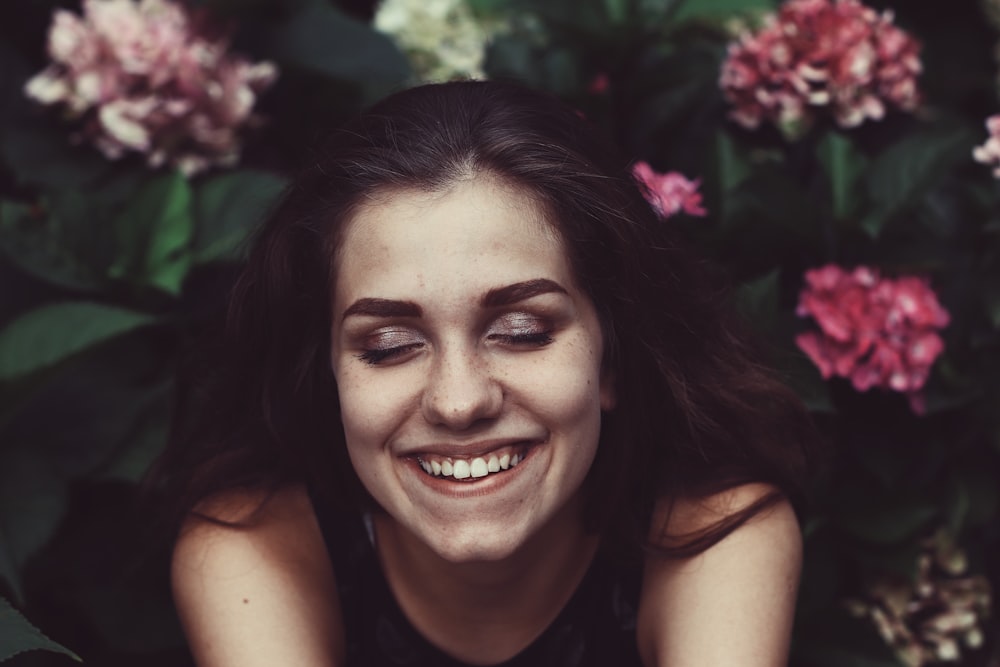 woman smiling face surrounded by flowers