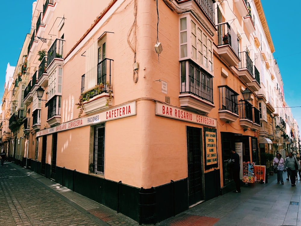 person standing near white painted building