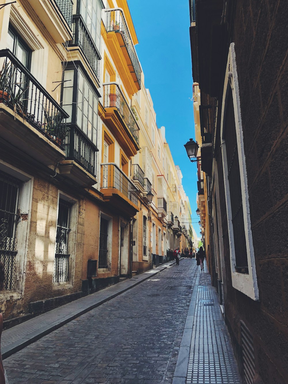 narrow pathway between concrete buildings