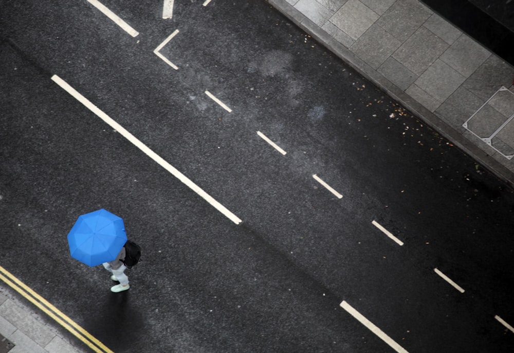 person under blue umbrella