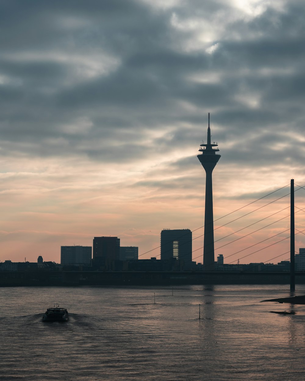 silhouette of tower under nimbus clouds