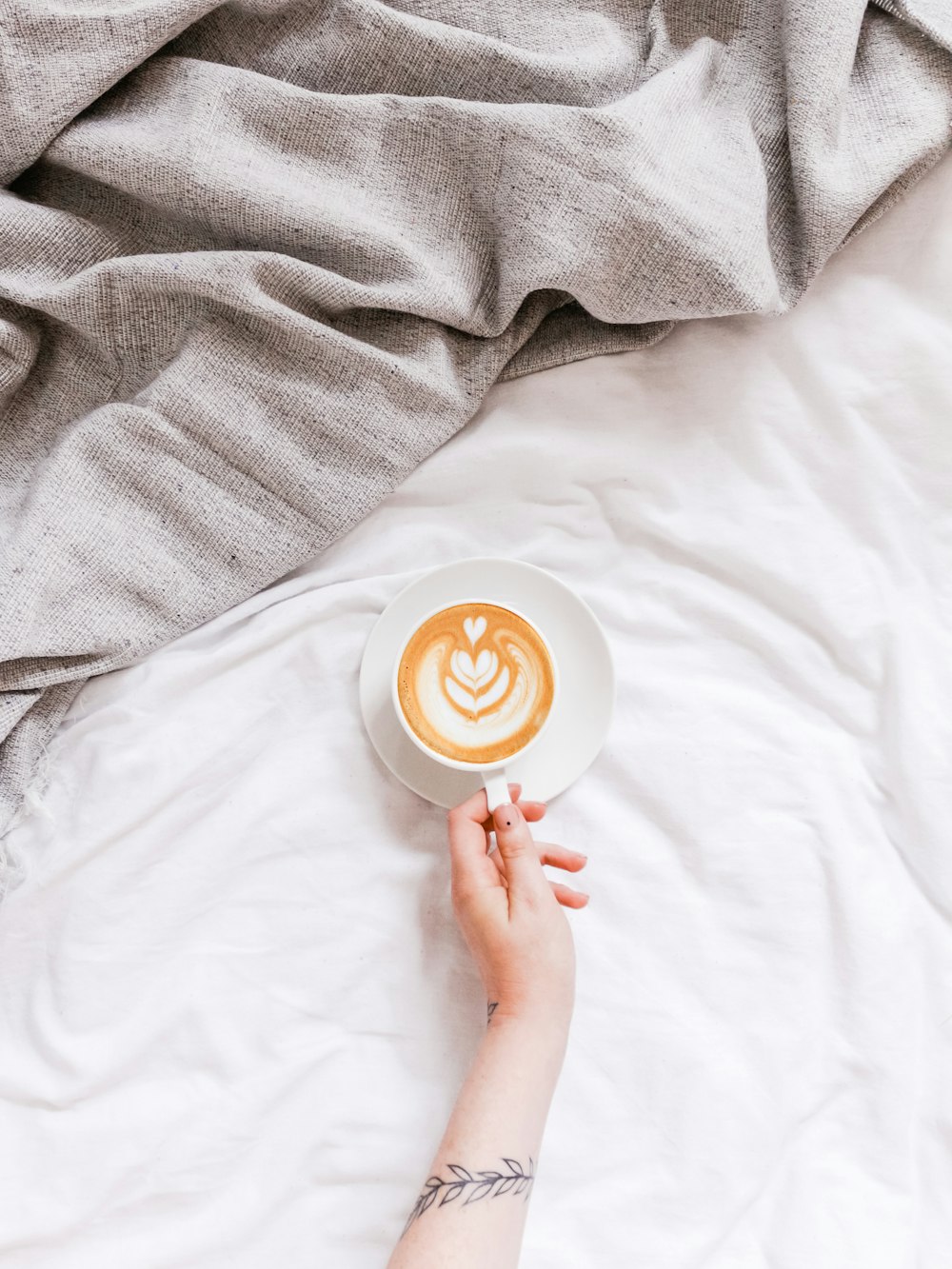 creamy coffee in white ceramic teacup