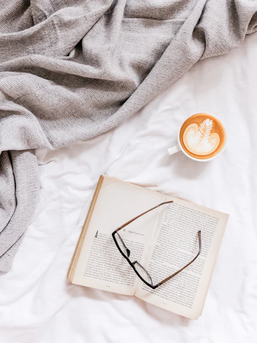Reading glasses resting on an open book