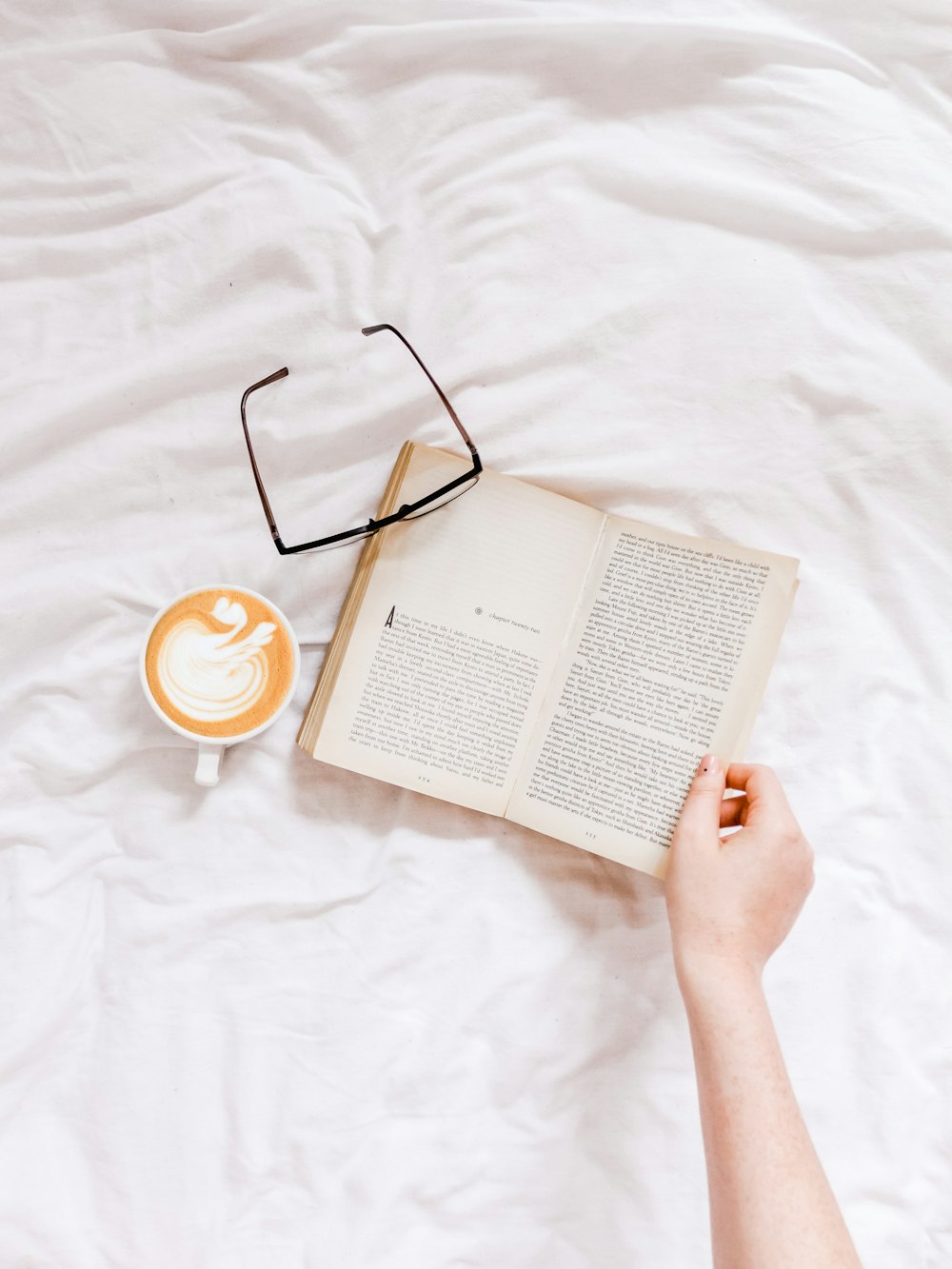 person touching opened book