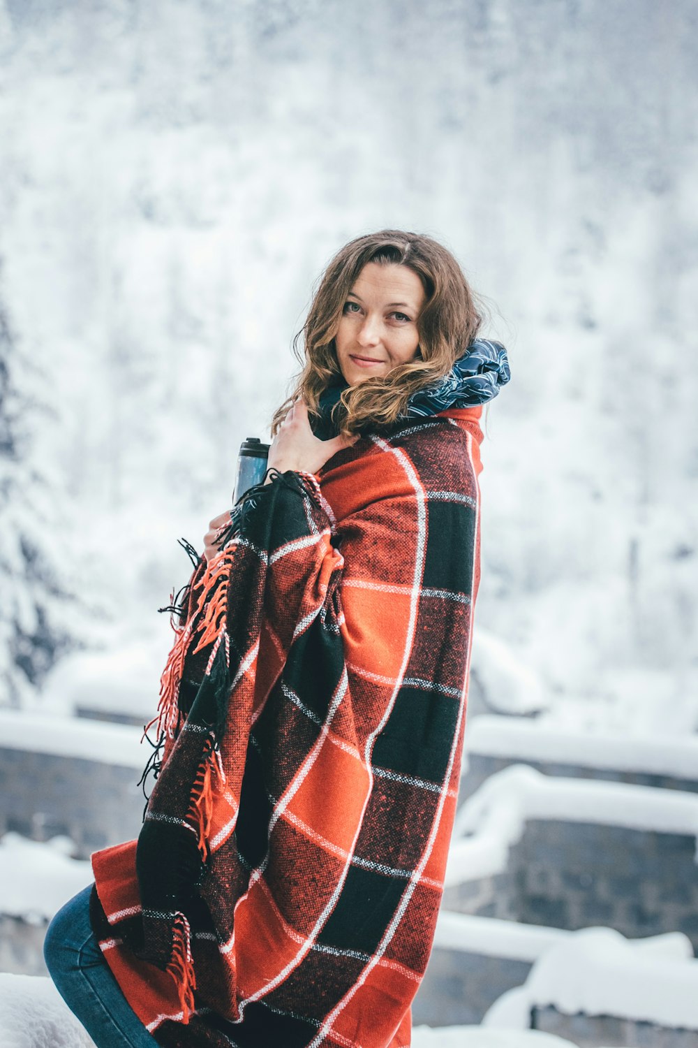 woman standing covered with blanket