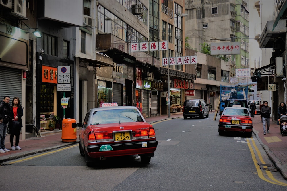 red taxi on road during daytime