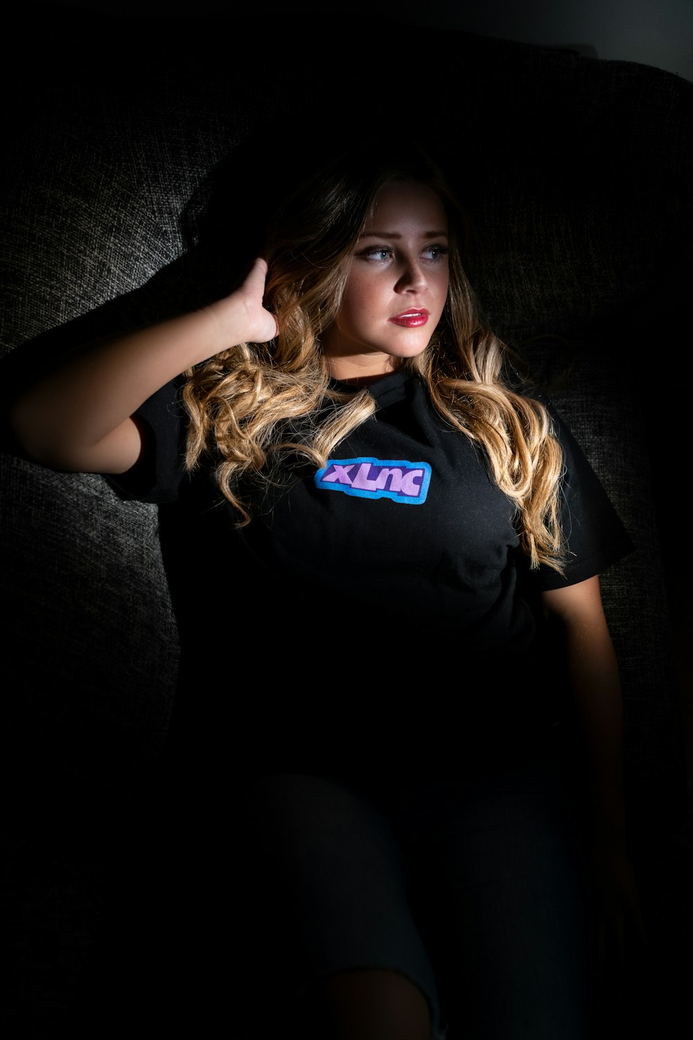 woman wearing black t-shirt lying on bed