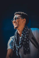 A cheerful customer wearing a signature mustara scarf on a sunny day.