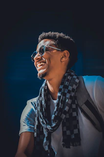 A cheerful customer wearing a signature mustara scarf on a sunny day.