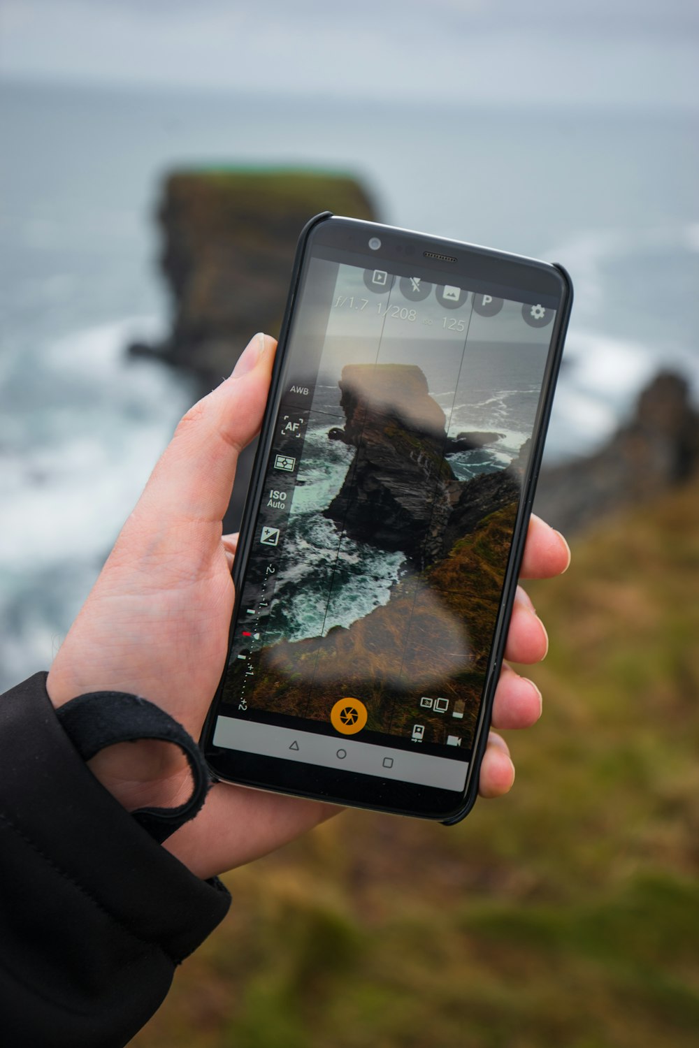 smartphone displays cliff on shore