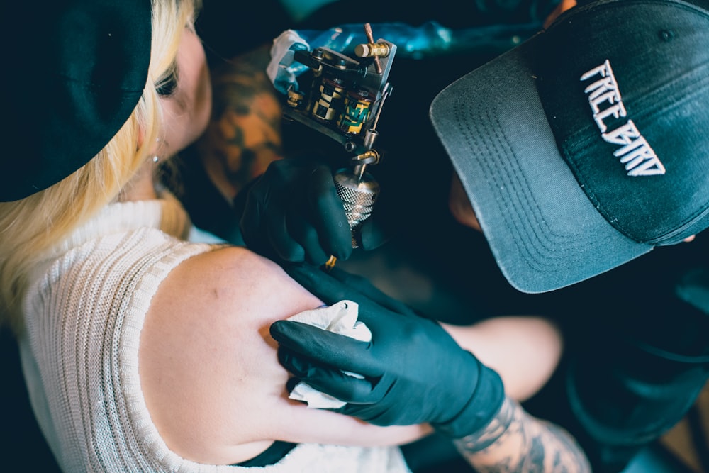 man tattooing woman