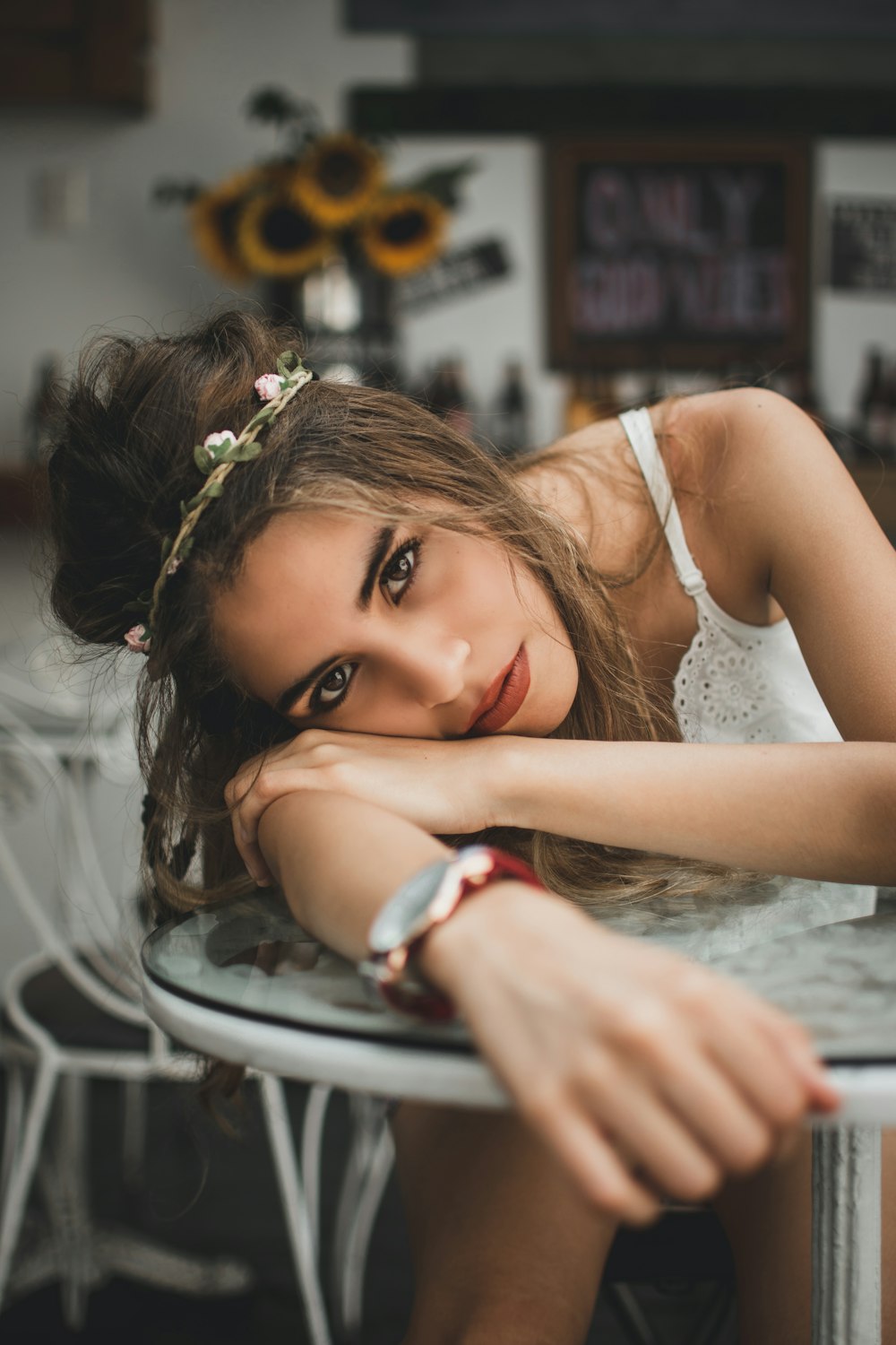 woman laying on coffee table wearing white top