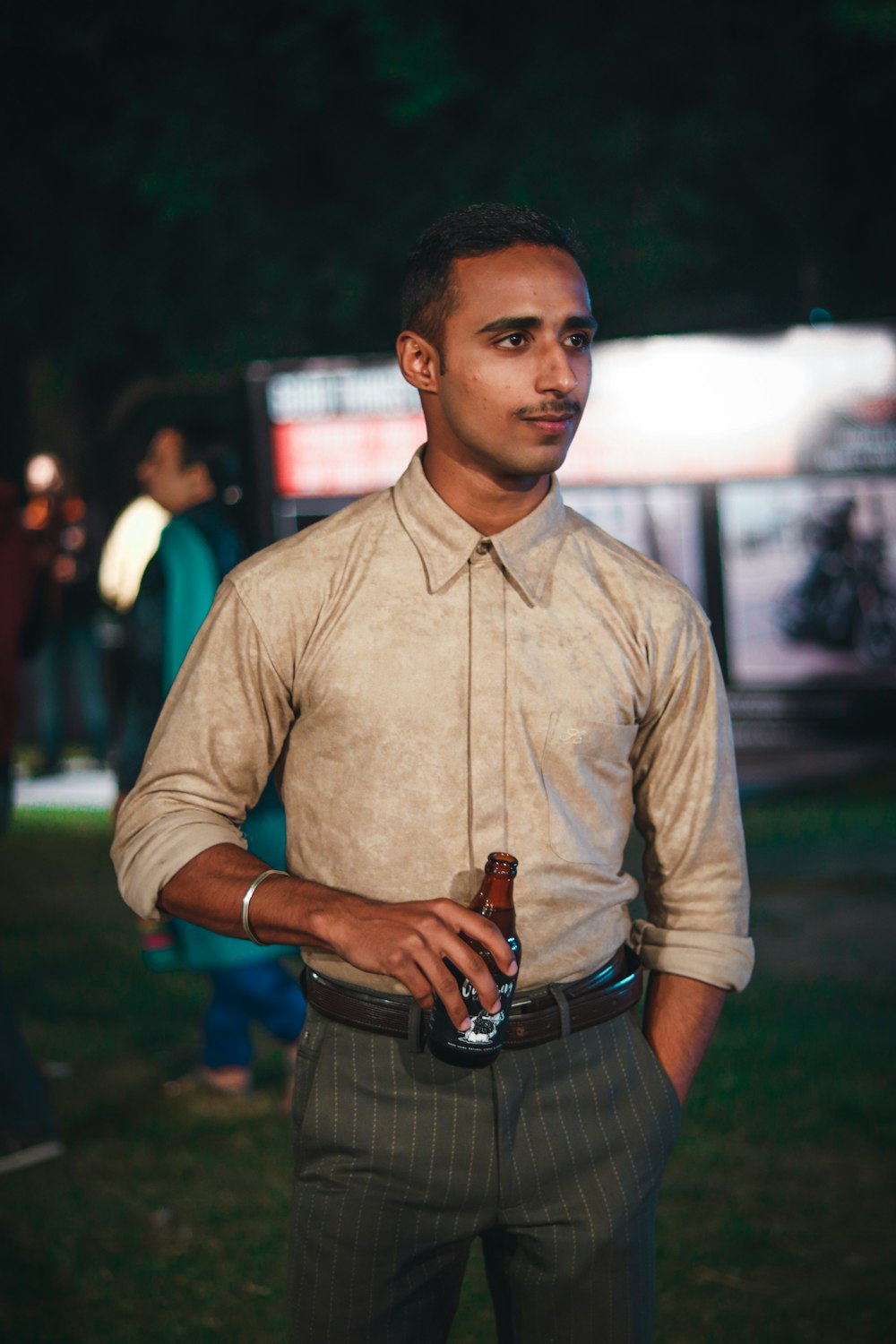 selective focus photography of man holding bottle