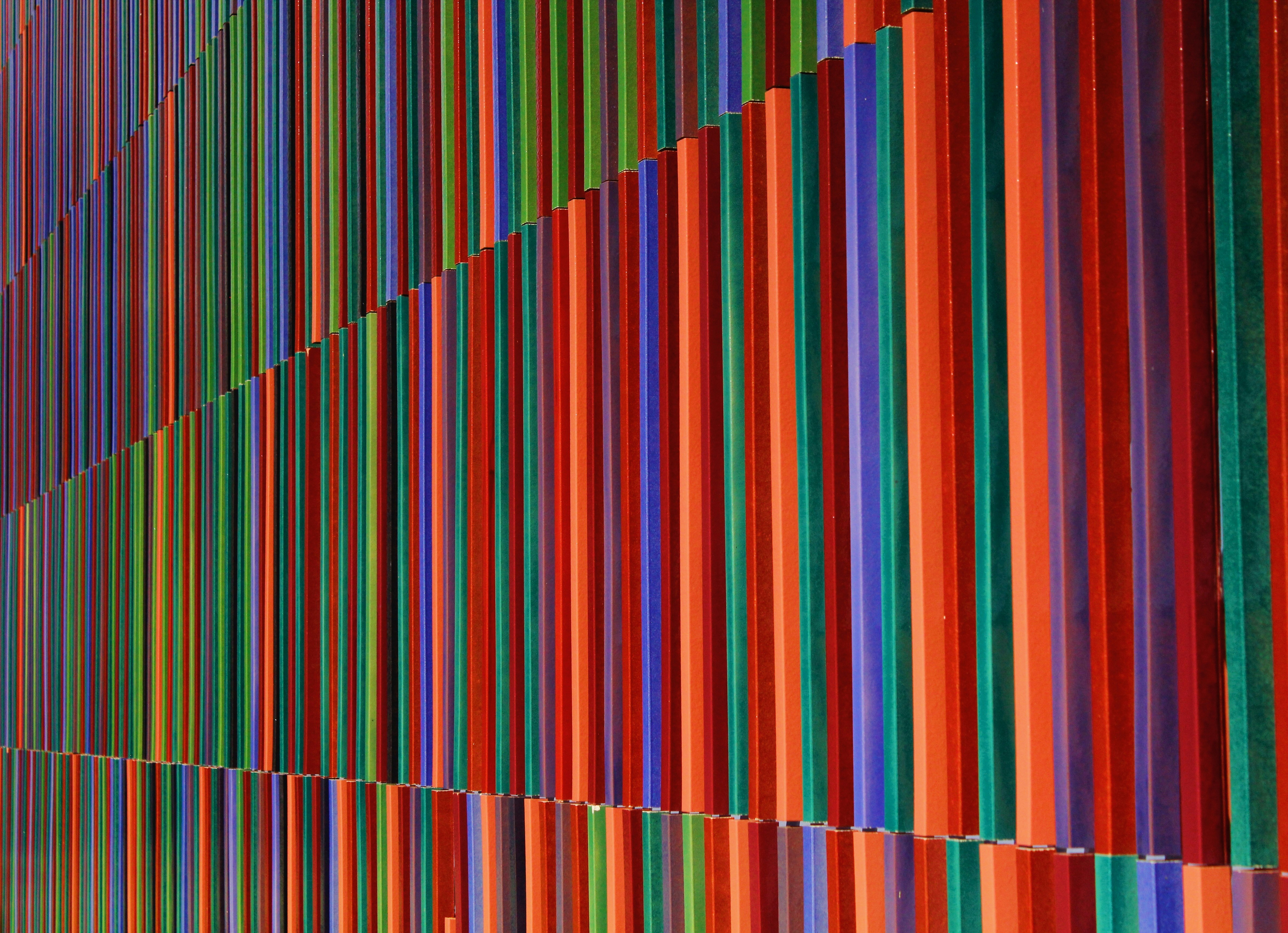 A vibrant, energetic photo of a large crowd at a political rally, possibly with Congress party flags, showing enthusiasm but no specific controversy.