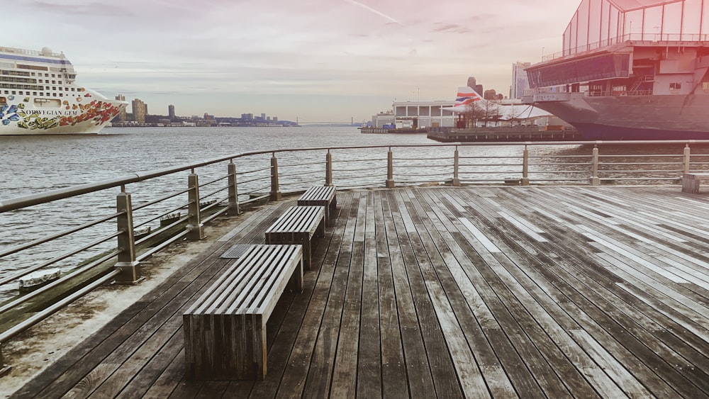 brown dock near ship under white sky during daytime