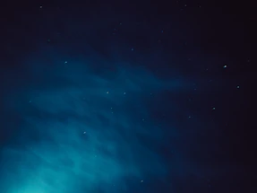 An elegant night sky with constellation lines subtly blended into a digital trading chart.