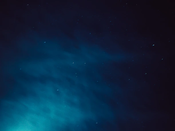 A mystical night sky with swirling galaxies and soft glowing stars, hinting at cosmic guidance.